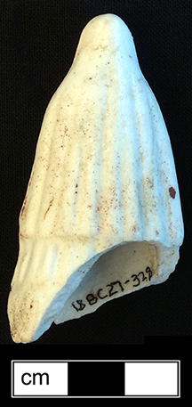 Red riding hood doll, with traces of red paint on the cloak, made of bisque porcelian. 6cm x 2.5cm x 3.25cm - from 18BC27.